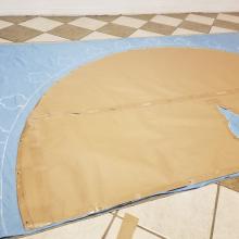Cloak template being traced onto final material
