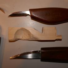 Carving knives and one partly carved waterwheel paddle.