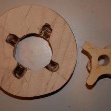 Wooden disk and cross-shaped bearing.